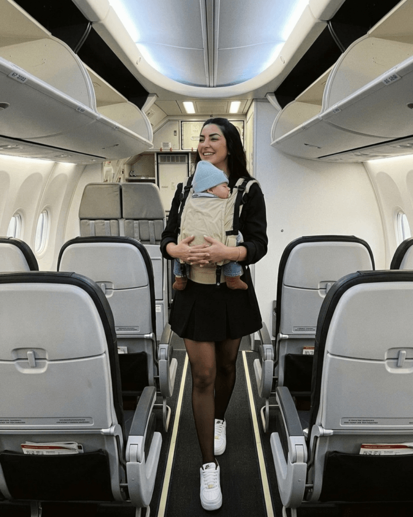 mama viaja con bebe en mochila de porteo 